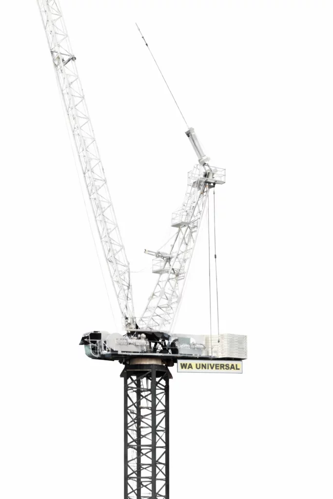 A large construction crane with a lattice boom stands against a white background. The base is black, and a box labeled "WA UNIVERSAL" is visible on the platform. The image is minimalistic and bright.