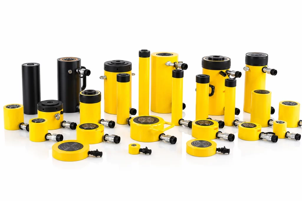 A variety of yellow and black hydraulic cylinders of different sizes and designs are arranged on a white surface, showing both vertical and horizontal orientations.