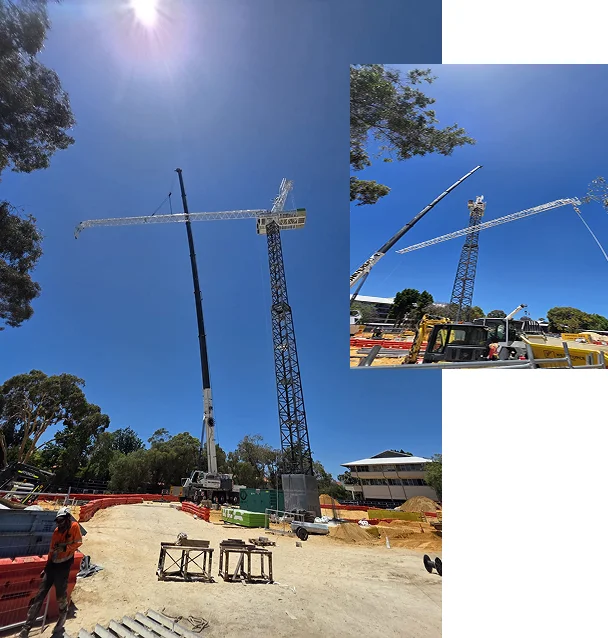 A construction site under a bright blue sky with cranes lifting materials. One worker stands on sandy ground, and trees and buildings are visible in the background. An inset shows a closer view of the crane assembly.