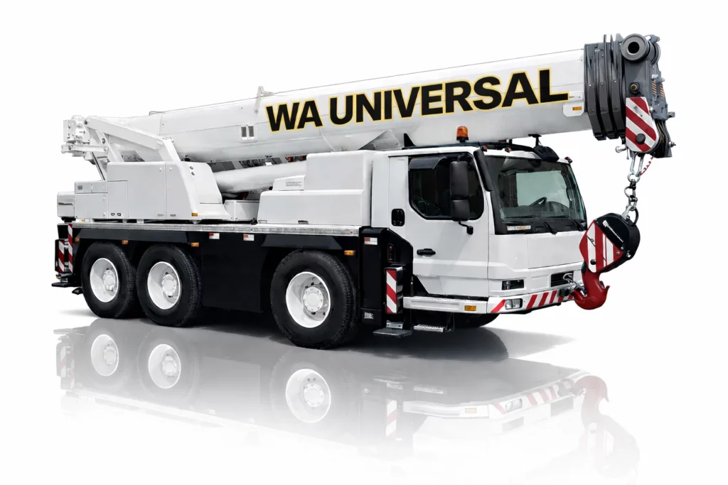 A large white mobile crane truck with "WA UNIVERSAL" written on its boom, featuring six wheels and a red-and-white striped hook. The vehicle is reflected on a glossy surface.